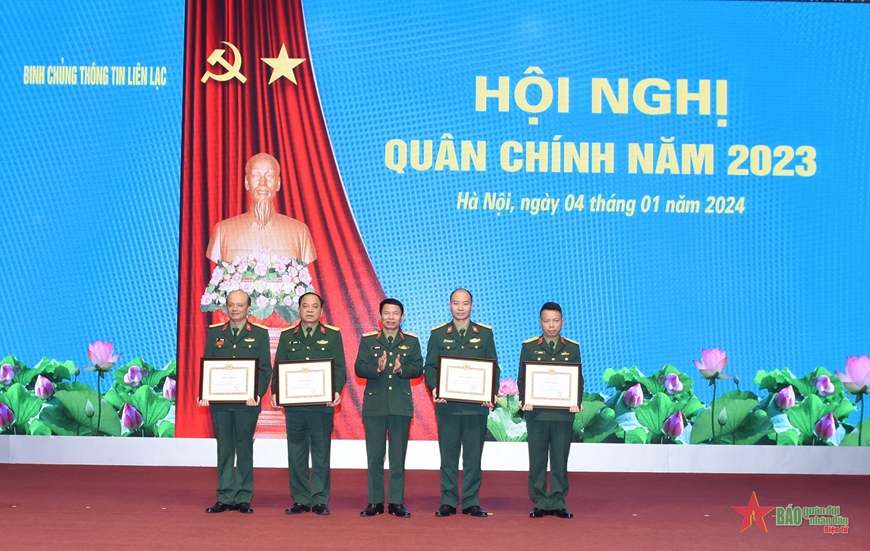 A group of men in military uniforms holding certificates

Description automatically generated